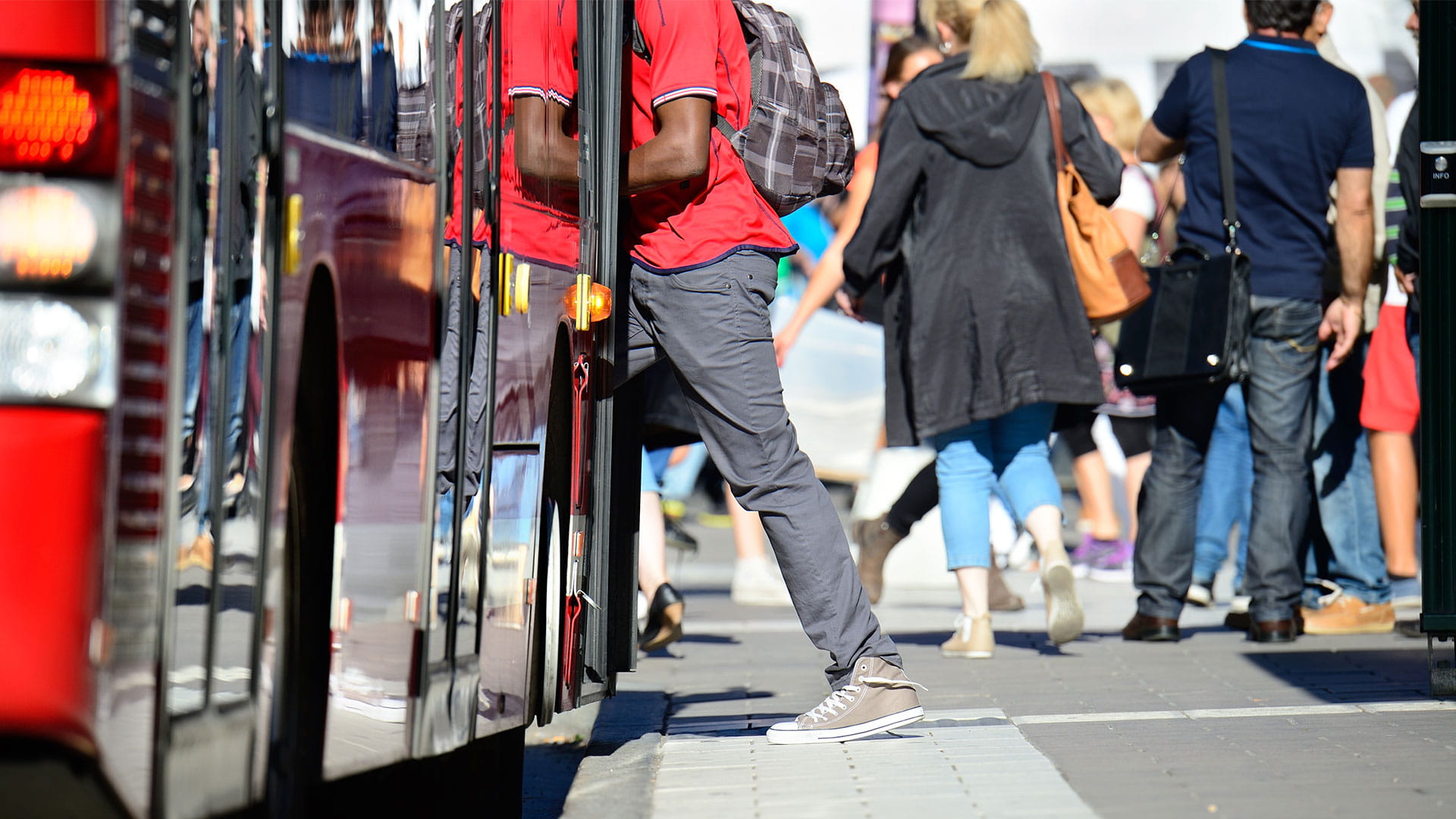 People stepping on the bus