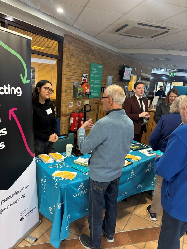 People talking around a booth