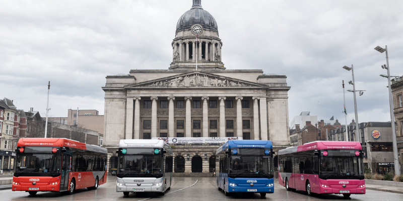 colorful buses in front of building