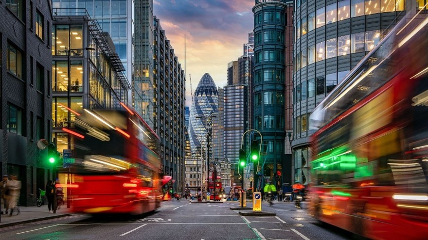 A city street with buses and buildings